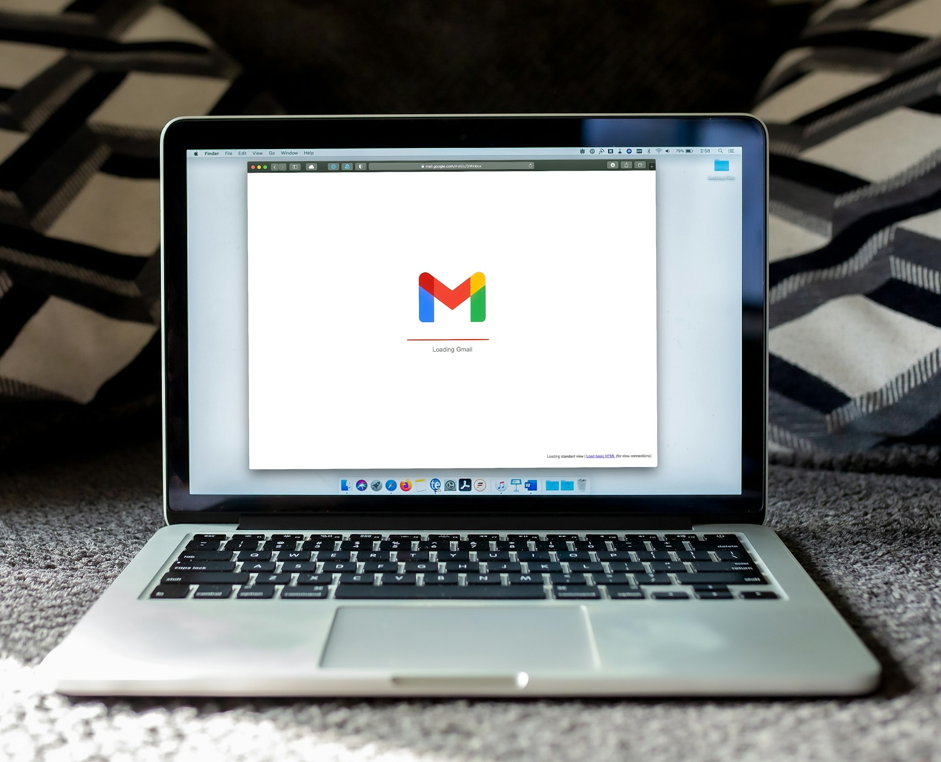 macbook pro laptop open to a desktop email client