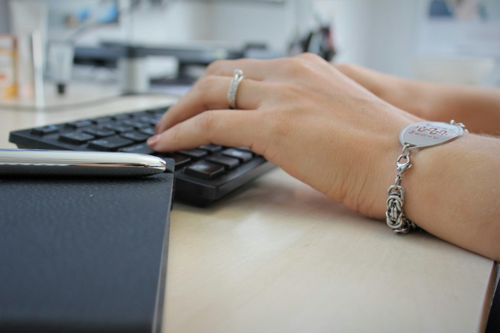 nurse practitioner typing on a laptop